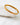 Auric gold-plated bangle bracelet with geometric texture.