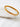 Auric gold-plated bangle bracelet with geometric texture.