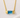 Austin Necklace close-up showing faceted blue bar pendant on gold chain.