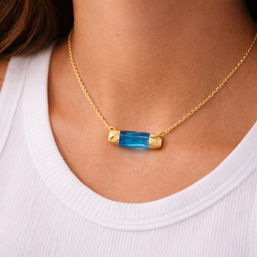 Austin Necklace worn on model featuring minimalist ocean-blue pendant layering look.