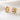 Bali Stud Earring in shiny gold with a sculptural knot design, styled as a polished statement stud for everyday jewelry looks.