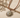 Bartu Necklace sun pendant necklace with braided cord on neutral textured background, showing radiant sun design and warm boho style.