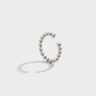 Silver beaded ear cuff on a light gray background