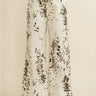 Biz Pants wide-leg ivory trousers with dark abstract splatter print, high-rise fit and relaxed drape, shown from waist down styled with white sneakers on neutral studio background.