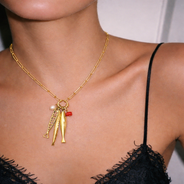 Blap Necklace gold charm necklace worn on model layered pendant necklace statement styling