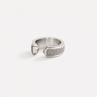 Bolzano Ear Cuff in polished silver featuring a bold open cuff silhouette with sparkling pavé crystal detailing, designed as a modern statement ear cuff on a soft neutral background.