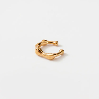 Bone Ear Cuff in polished gold with an organic fluid silhouette and rounded sculptural details, designed as a minimalist statement ear cuff with a modern high-shine finish.
