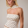 Bonyo Top worn on model featuring polka dot halter neckline and fitted bodice.