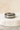 Silver ring with embedded zirconia stones displayed on neutral stone background – Brillance Ring by Matte
