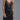 Black satin slip dress with delicate lace trim and fluid silhouette, shown on model layered with gold jewelry — Cala Dress by Matte.

