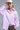 Pink and white striped button-down shirt with embroidered red heart detail on the chest, shown on model with relaxed fit — Cayana Shirt by Matte.
