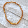 Snake chain necklace in gold plated finish, bold thick chain with smooth fluid texture, flat on neckline, Matte jewelry.
