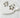 Gold plated star-shaped hoop earrings displayed on a white stone — Charleroi Hoop Earrings by Matte.