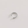 Claude Ear Cuff in polished silver featuring a rounded beaded open cuff design, styled as a sleek minimalist ear cuff on a soft neutral background.