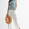 Clea Pant full outfit styling with embroidered white pants and sleeveless top on model.