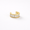 Gold ear cuff with baguette cut diamonds on a white background