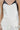 Model wearing the Lennon two-tone ivory satin cami with black faux-leather accents, close up.