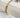 Gold plated multi-strand box chain bracelet with elegant clasp displayed on a wooden surface by Matte jewelry