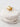 Gold ear cuff on a stack of white stones