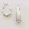 Elera Hoop Earrings — silver sculptural tapered hoop earrings with mirror finish on neutral background, minimalist and elegant jewelry.