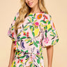 Model wearing the Enus Top in abstract print cotton with short balloon sleeves and relaxed fit. 