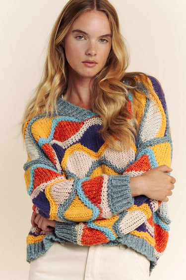 Bold knit design of the Eon Sweater with vibrant color waves.