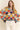 Model wearing Eon Sweater, multicolor knit with wave pattern, front view.