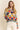 Full body view of Eon Sweater paired with rolled-up pants and sandals.