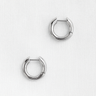 Evoa Huggie Earrings — minimal silver plated huggie earrings with mirror finish on neutral linen background, polished and modern jewelry by Matte.