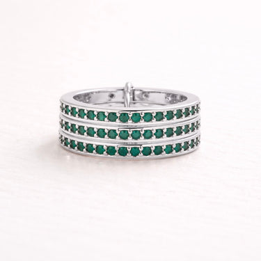Ezer Ring multi-row pavé band ring with green stones in silver finish on neutral background.