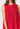 Model wearing red Gigi Dress with sleeveless cut and eyelet texture.