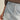 Girona Mini Short light-wash denim mini skort front close-up with seam detailing.