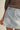 Girona Mini Short light-wash denim mini skort front close-up with seam detailing.