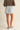 Girona Mini Short worn by model back view with light-wash denim and structured shape.