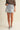 Girona Mini Short worn by model front view with light-wash denim finish.
