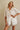 Godeth Blouse front view highlighting crisp white eyelet fabric, button-front shirt shape, and feminine scalloped edges