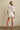 Godeth Blouse back view showing white eyelet texture, short sleeves, and scalloped hem with matching shorts.