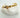 Gold engraved bangle bracelet resting on white stone background — Fendy Bangle Bracelet by Matte.
