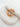 Gold Sculptura Ear Cuff with fluid curves and bead accents displayed on white stone