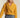Mustard cropped coat paired with light blue jeans, casual chic look
