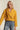 Mustard cropped coat paired with light blue jeans, casual chic look
