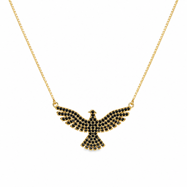 Grim Necklace gold phoenix pendant on neutral background, highlighting wing shape, black stone detailing, and statement design