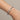 Haddy Bangle Bracelet silver twisted cable bracelet worn on wrist with polished horseshoe clasp detail, modern stainless steel cuff design with sleek luxury finish and minimalist styling.**
