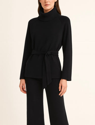 Woman wearing Hailee Lounge Sweater Set in black, featuring knit turtleneck top with waist tie and wide-leg pants.