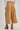 Back view of High-Rise Pleated Culotte Pants in taupe with wide cropped leg, pleated details, and cuffed hem