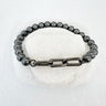Homa Bracelet with polished beads and bold chain link accent on neutral stone background – Matte Jewelry Collection