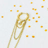 Inami gold hoop earring with chain on a white background with yellow stars
