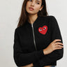 Iplo Zipper Jacket worn on model featuring cropped bomber fit with heart detail on front.