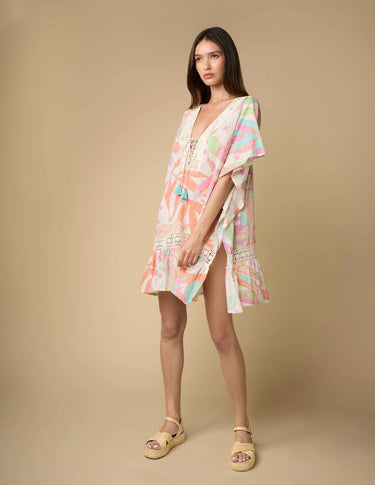 Full view of Irvine Tunic showing pastel abstract print and lace-up neckline with tassels.