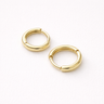 Iskra Huggie Earrings – polished gold huggie earrings in a slightly larger size, photographed on a soft neutral background.